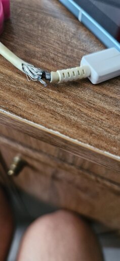 A cable whose wires seem to be exposed.